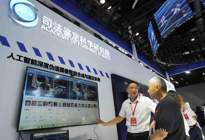 图为观众观看由司法鉴定科学研究院与中科睿鉴科技有限公司共同研发的人工智能深度伪造图像智能合成与鉴定系统。